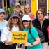Tour group holding a Food Trail Istanbul sign in front of colorful buildings in Balat.