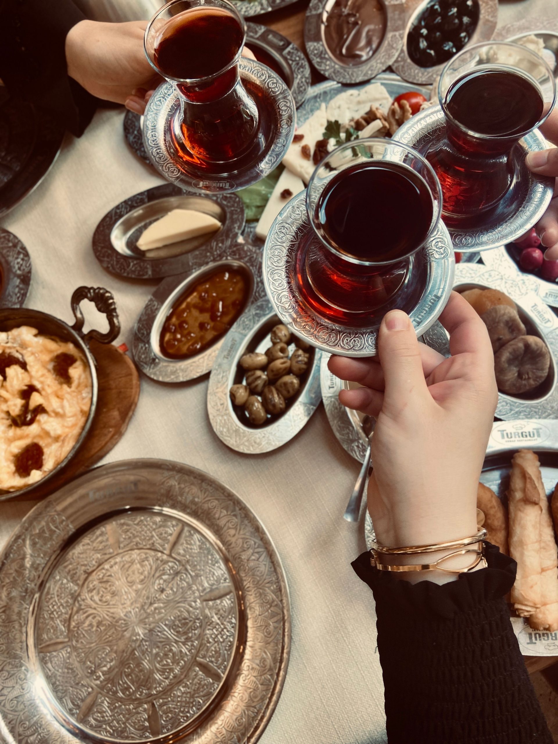 A table filled with iconic foods in Istanbul and glasses of Turkish tea