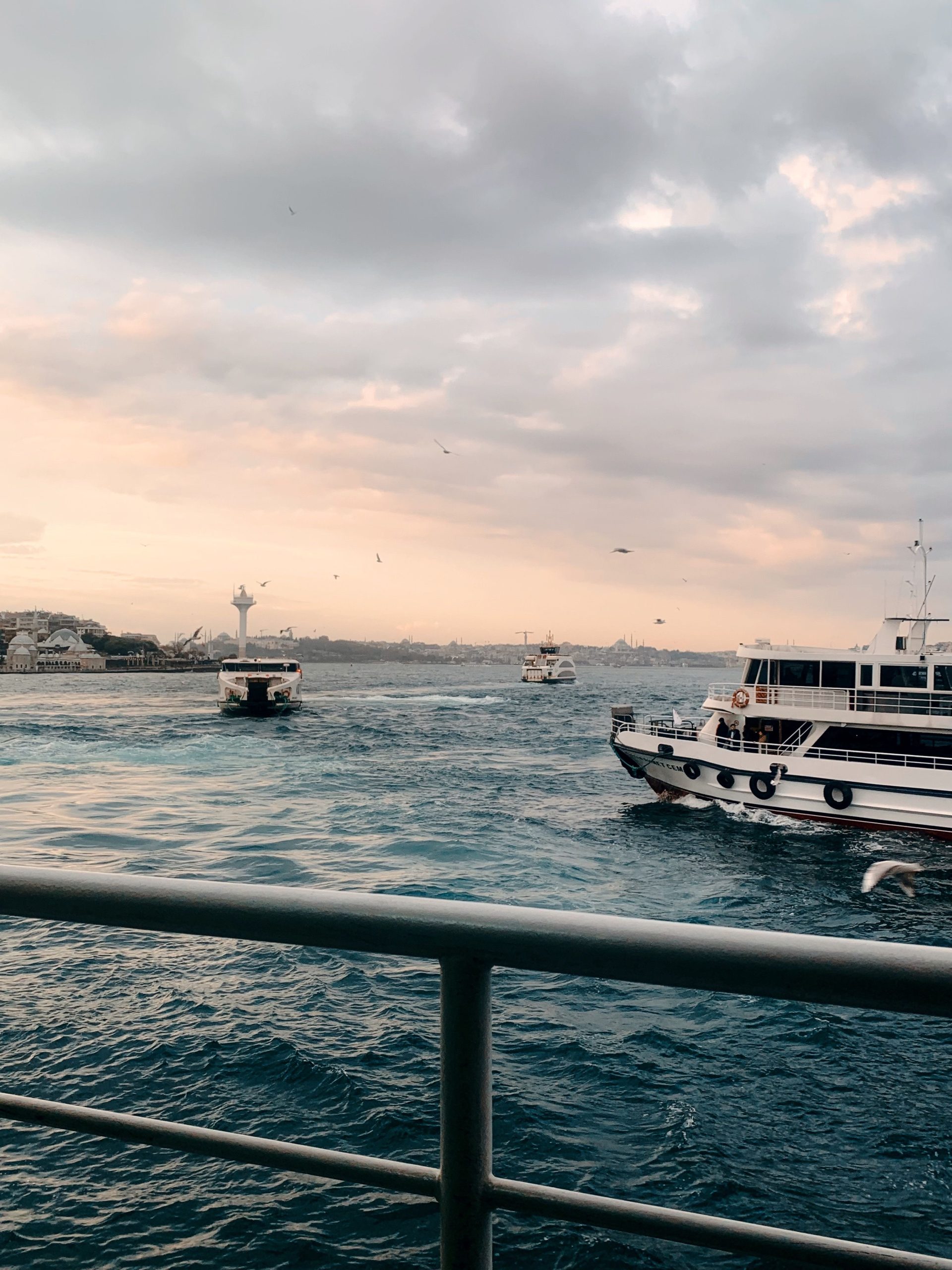 Morning ferries crossing the Bosphorus at sunrise in Istanbul